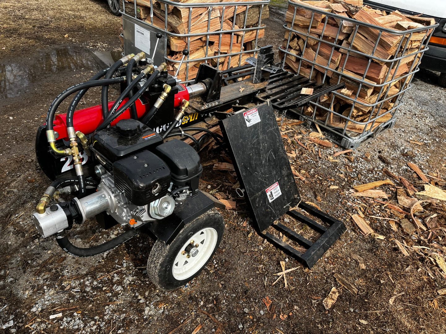Our wood splitter and caged firewood ready for delivery