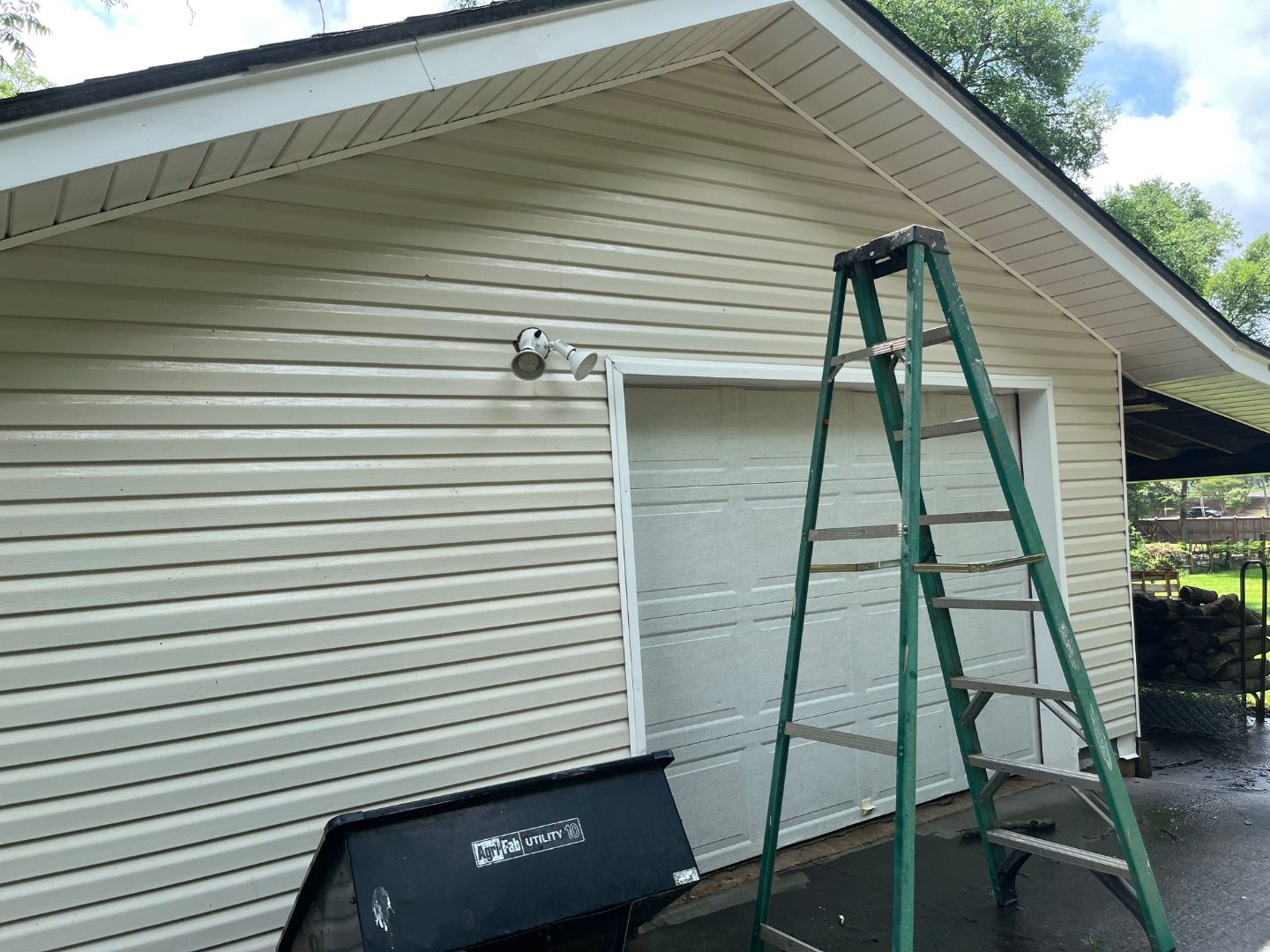 Dirty garage siding before pressure washing